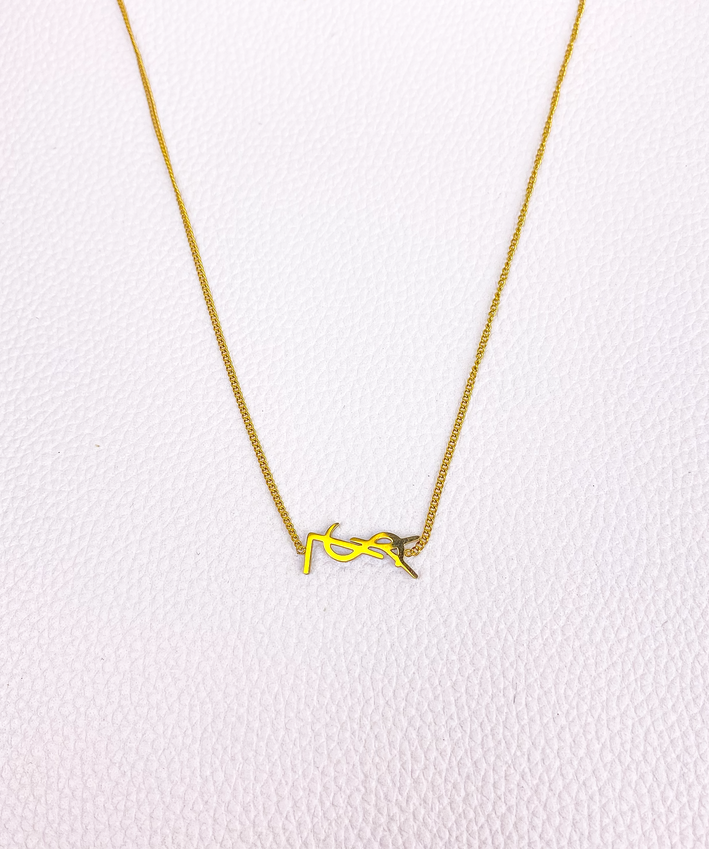 gold YSL necklace